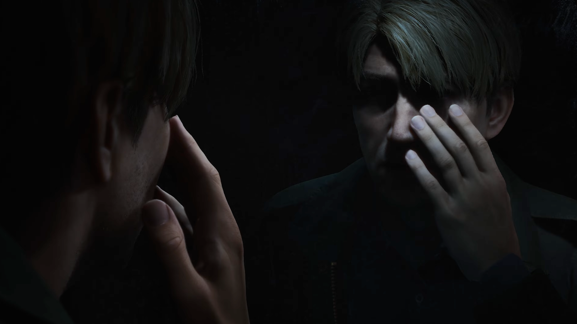 A man standing before a mirror in near darkness, his reflection raising a hand to its own face